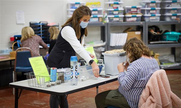 Teacher helps student file papers
